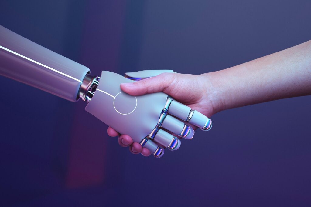 Handshake between a human and a robot representing AI